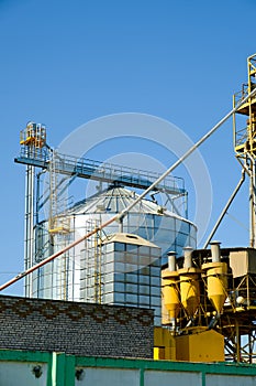 Agricultural Silos. Building for storage and drying of grain crops. Modern granary elevator. Agribusiness concept