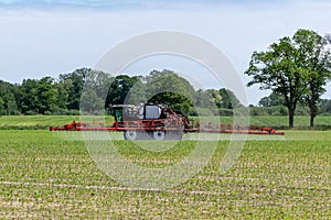 Agricultural sprayer treated emerging corn