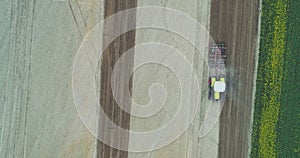 Agricultural tractor cultivating field.