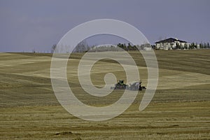 Agricultural tractor in a farm field preparing for planting