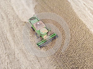 Agricultural tractor harvesting soybeans in the field