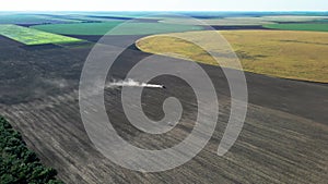 Agricultural tractor performing fall tillage in stubble field