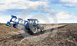 Agricultural tractor with plow