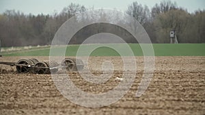 Agricultural tractor sowing and cultivating field