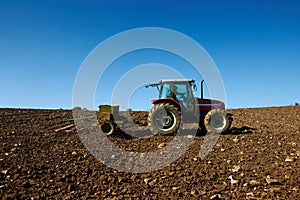 Agricultural tractor sowing seeds