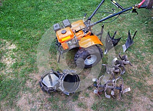 Agricultural walk-behind tractor with a set of attachments, hiller, milling cutters and lugs. Two-wheel tractor