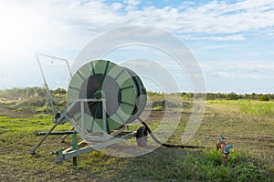 Agricultural water pipeline at farm with blue sky.