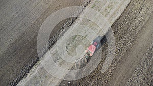 Agriculture - aerial view of harvest fields with tractor