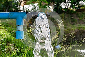 Agriculture blue pipe with groundwater gushing