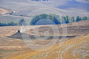 Agriculture concept with tractor working in Tuscany, Italy