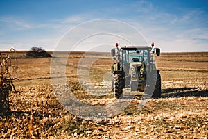 Agriculture details - Tractor and industrial machinery working the corn fields
