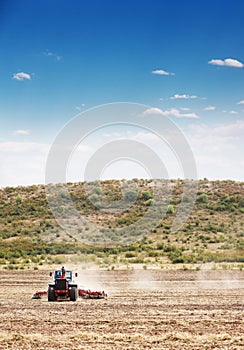 Agriculture farm tractor plowing in the filed