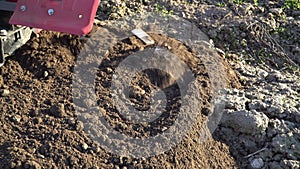 Agriculture. Farmer`s car. Cultivator mills plowing the ground