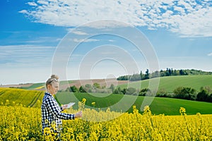 Agriculture Farmer Using Digital Tablet Examining Crops