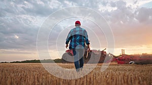 agriculture. farmer walk works in a field next to a tractor that plows the land. business agriculture concept. farmer