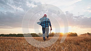 agriculture. farmer walk works in a field next to a tractor that plows the land. business agriculture concept. farmer