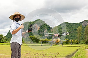 Agriculture farmer woman holds tablet to view a report on rice agriculture field, agriculture technology concept. Agriculture