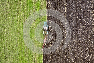 Agriculture. Farming. Tractor working in field. Aerial view. Tractor cultivating field.