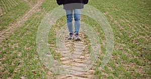 Agriculture - female farmer walking on agricultural field