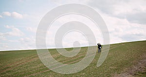 Agriculture - female farmer walking on agricultural field