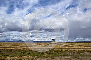 Agriculture Field And Equipment Under Storm Skies