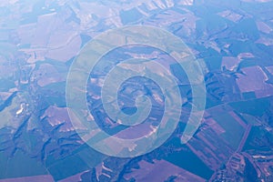 Agriculture fields and hill landscape view from an airplane