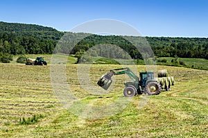 Agriculture machinery on hay field