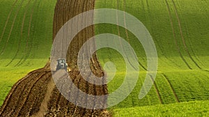 Agriculture on Moravia rolling hills with wheat filds and tractor