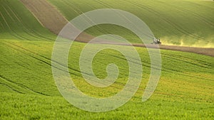 Agriculture on Moravia rolling hills with wheat filds and tractor