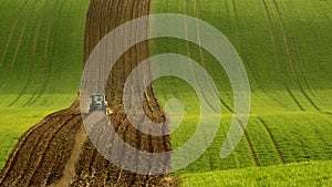 Agriculture on Moravia rolling hills with wheat filds and tractor photo