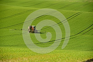 Agriculture on Moravia rolling hills with wheat filds and tractor photo