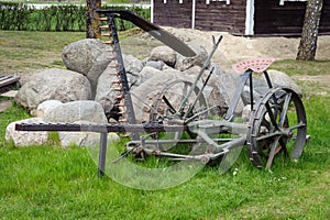 Agriculture old antique plough on grass, equipment for farming