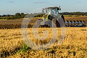 Agriculture plowing tractor on wheat cereal fields