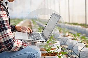 Agriculture technology concept man Agronomist Using a Laptop in an Agriculture Field read a report, Plant analysis and research