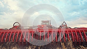 Agriculture. tractor plows a field of black soil against the background of blue clouds lifestyle. agriculture business