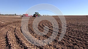 Agriculture tractor sowing seeds and cultivating field