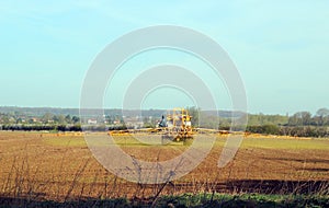 Agriculture-Tractor spraying crops.