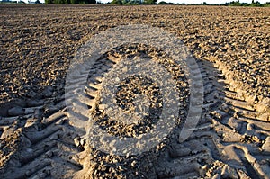 Agriculture tractor wheels traces on field soil