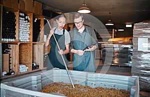 Agriculture, wine and vineyard workers in the alcohol business, press grapes in distillery plant. Sustainability, nature