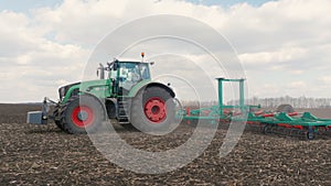 Agrobusiness - tractor running in the field in the spring 3-axis stabilized video