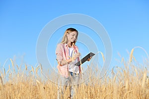 Agronomist with clipboard in field. Cereal grain crop