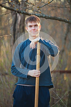 Agronomist handsome strong man with shovel on background of flo