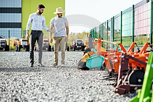 Agronomist with salesman at the agricultural shop