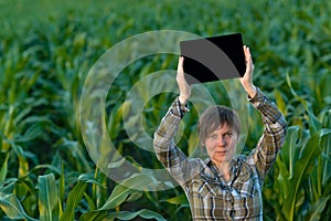 Agronomist with tablet computer in corn field