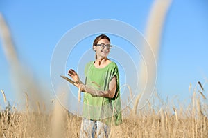 Agronomist with tablet in field. Cereal grain crop
