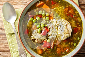 Aguadito de pollo Peruvian soup with cilantro, vegetables and chicken closeup on the bowl. Horizontal top view photo