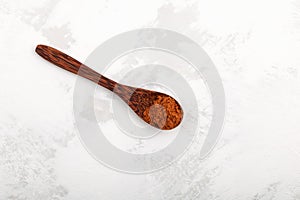 Aguaje powder in wooden spoon. Dried and pulverized pulp of aguaje provides great nutritional value and medicinal benefits,