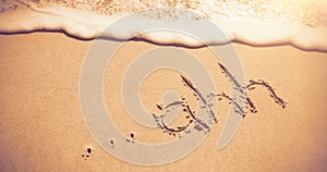 Ahh written on sand at beach with waves