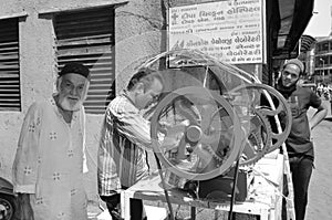 Ahmedabad: Two mens are reparing a sweet sugar cane machine