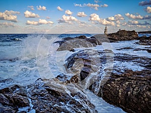 Ahtopol Lighthouse and waves crushing rocks